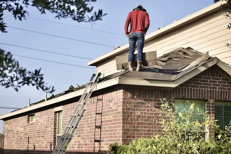 Professional roofer working on a residential roof in Damascus